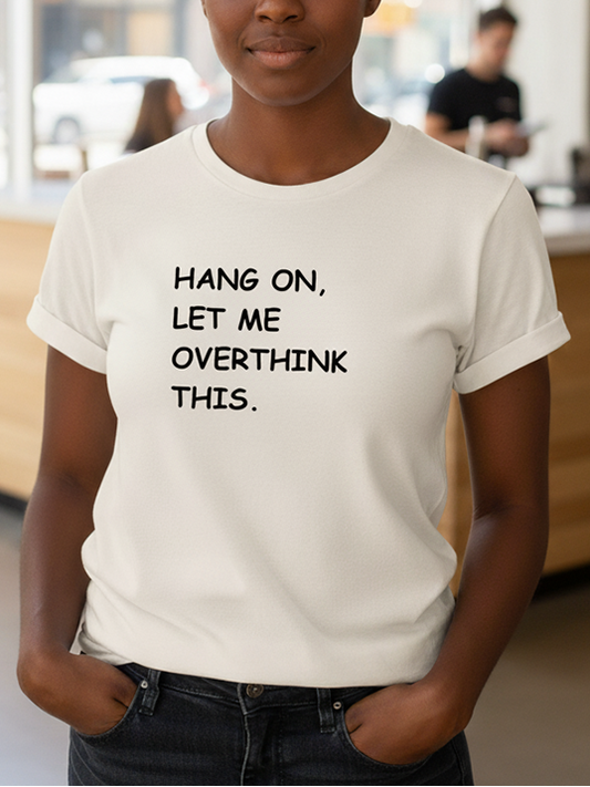 Person wearing a white t-shirt with text in a casual setting