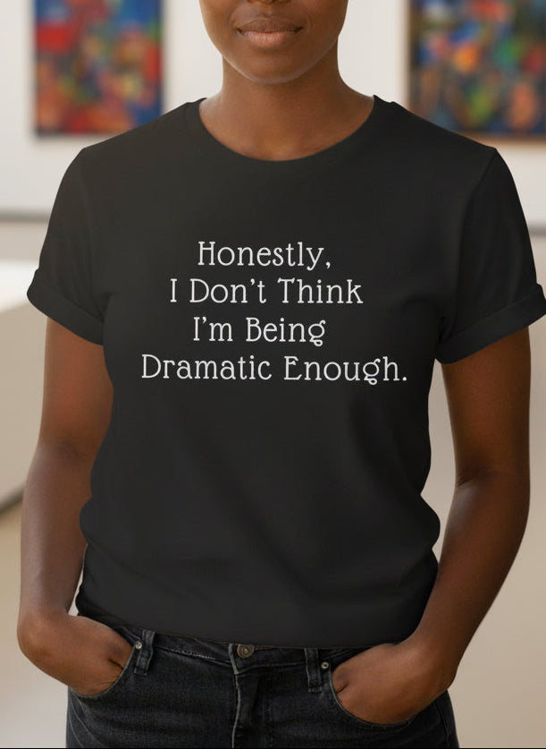 Person wearing a black t-shirt with text in an art gallery